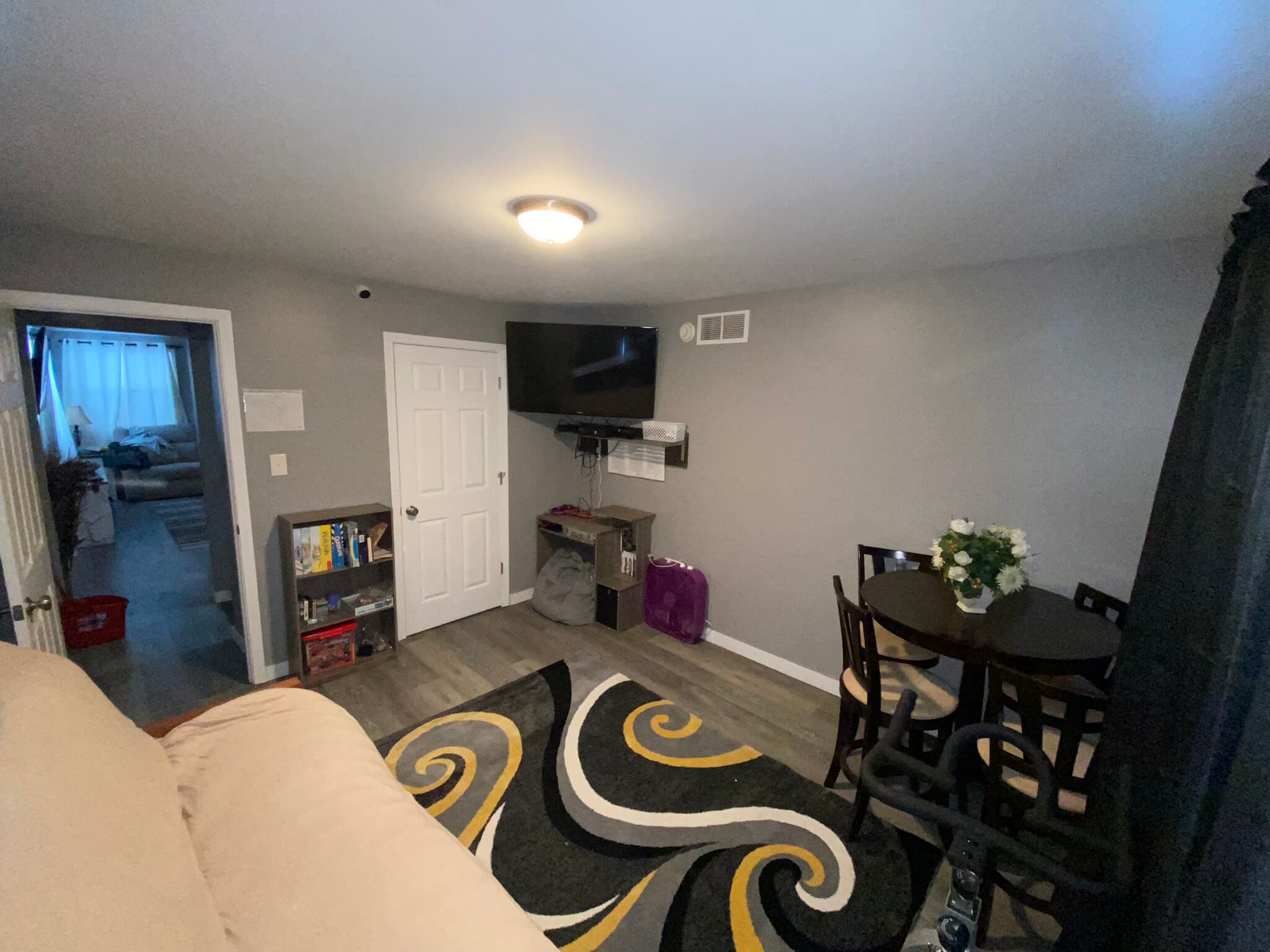 Library and game room space with a futon table and TV